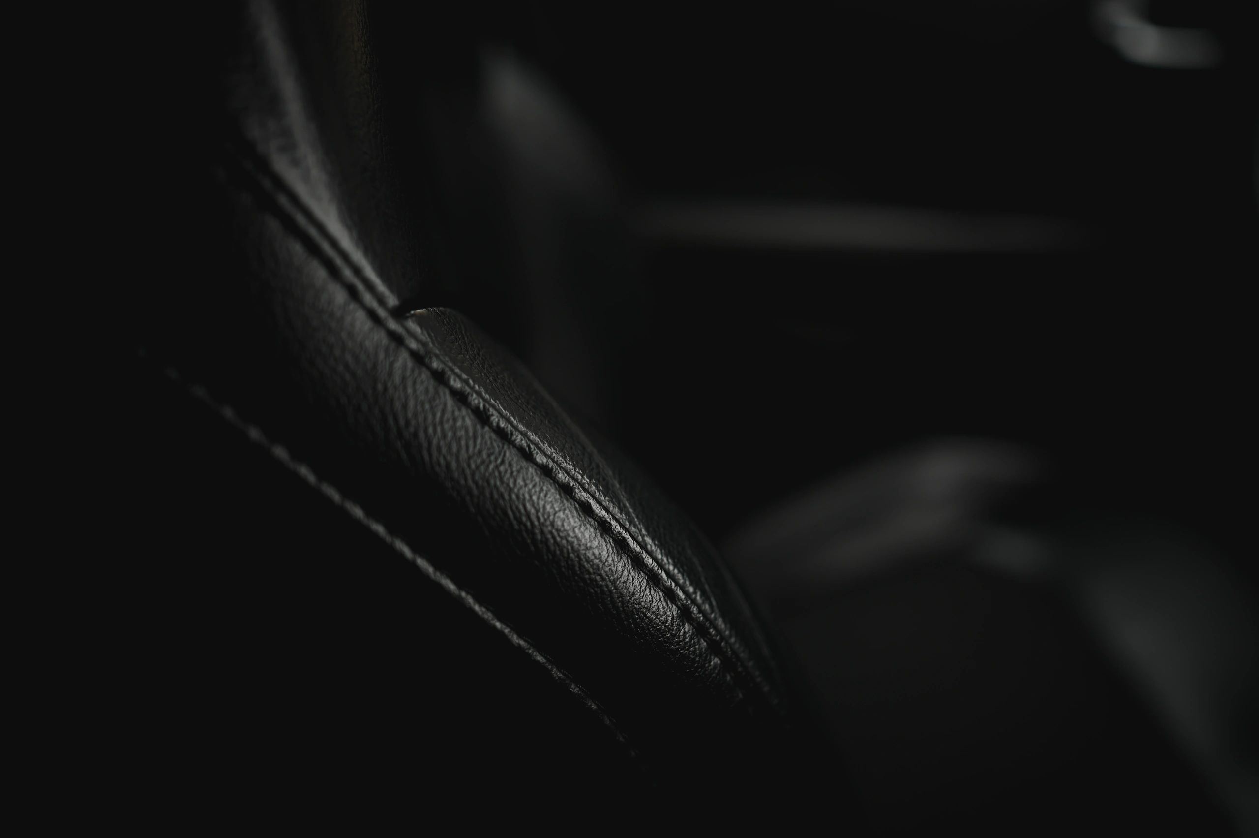 Close-up of luxury leather car interior stitching