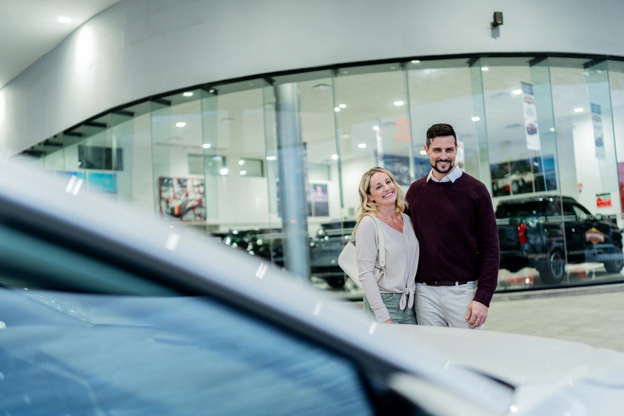 Couple viewing a car at a dealership